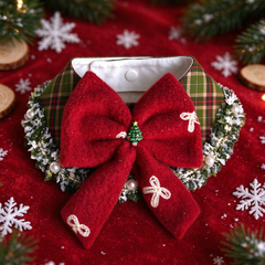Christmas plaid pet bow collar flat lay, red fuzzy bow with lace mini bows, frosted pine and pearl edge, red festive backdrop