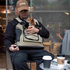 PawHavens pet front carrier backpack, man sitting outdoors with small dog inside carrier