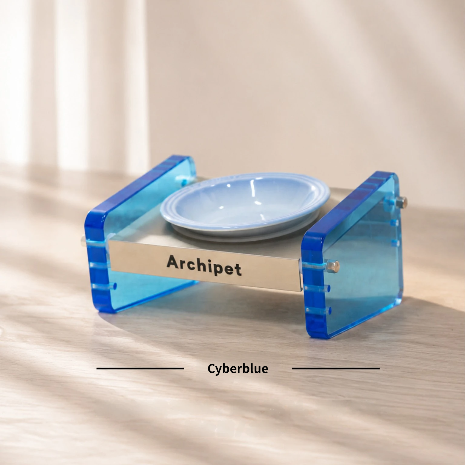 Archipet Cyberblue translucent acrylic raised cat feeder with light blue ceramic bowl, adjustable pet food stand on wooden table, minimalist home aesthetic pet product