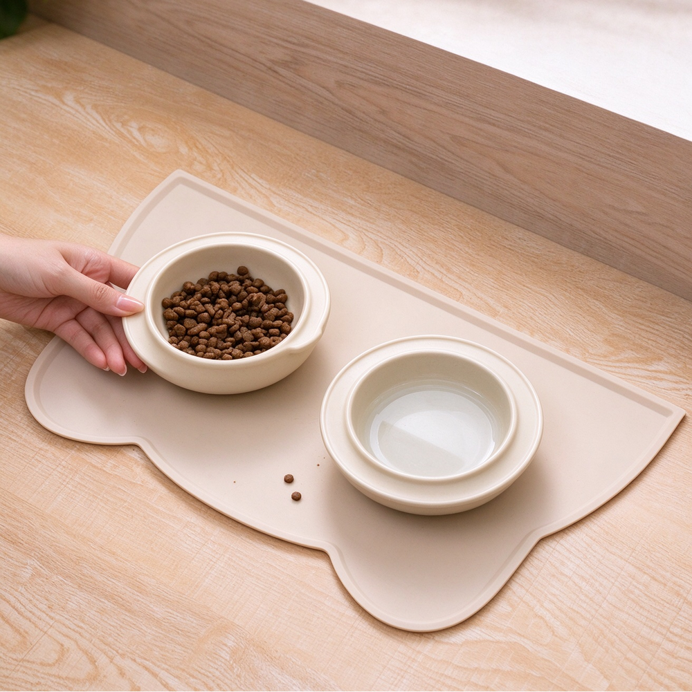 Cat ear silicone pet mat with dog food and water bowls on wooden floor
