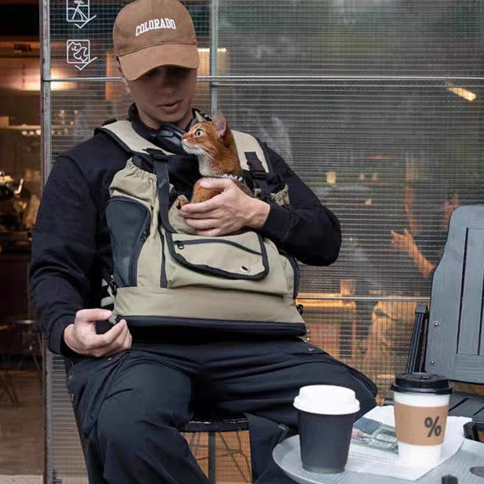 PawHavens pet front carrier backpack, man sitting outdoors with small dog inside carrier