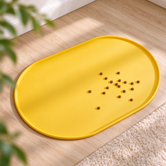 Yellow silicone pet feeding mat with scattered dog kibble